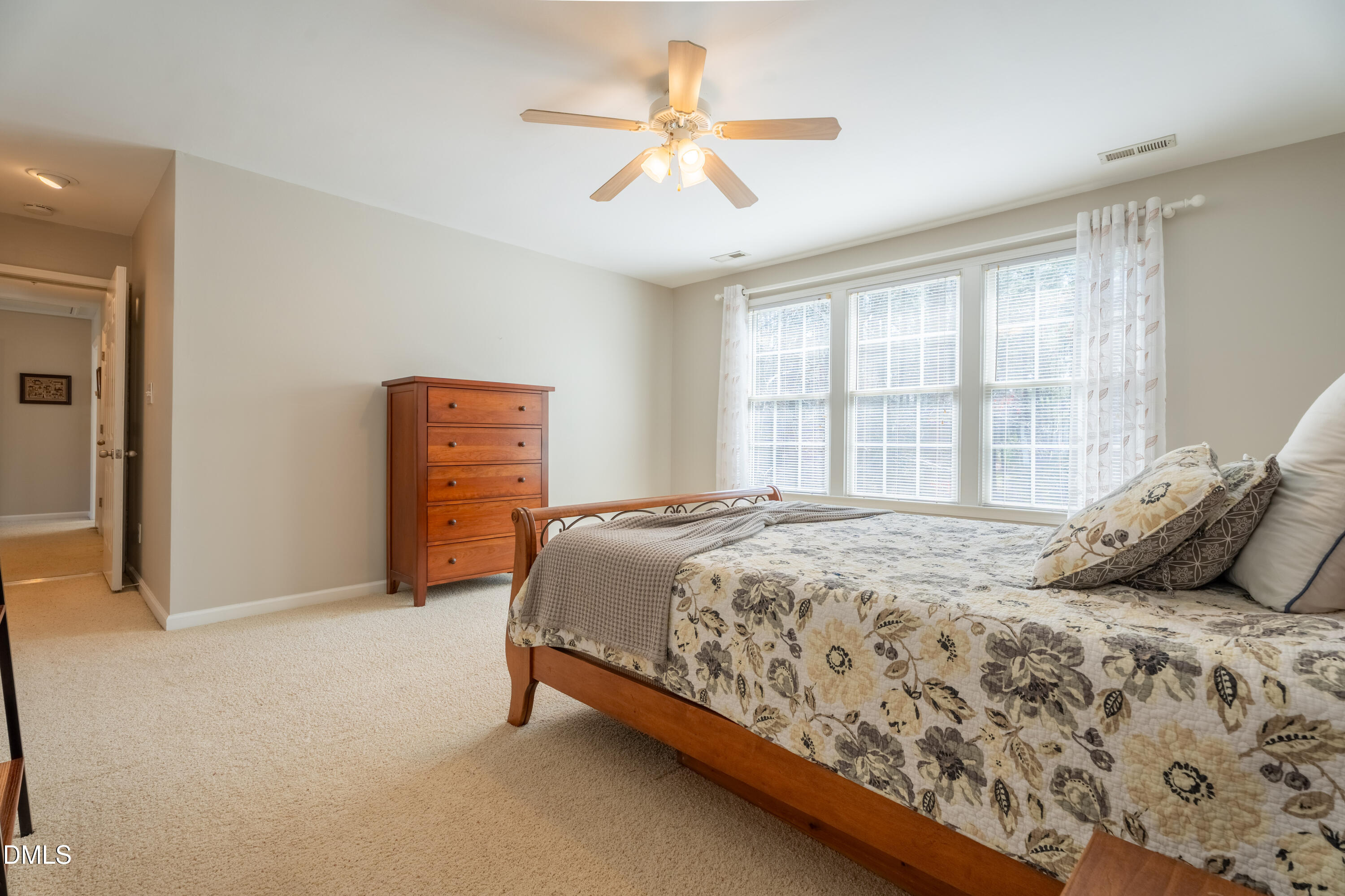 1305 Olde Walker Mill Road Apex, NC 27502 - Photo 30 of 41 a bedroom with a bed and a ceiling fan