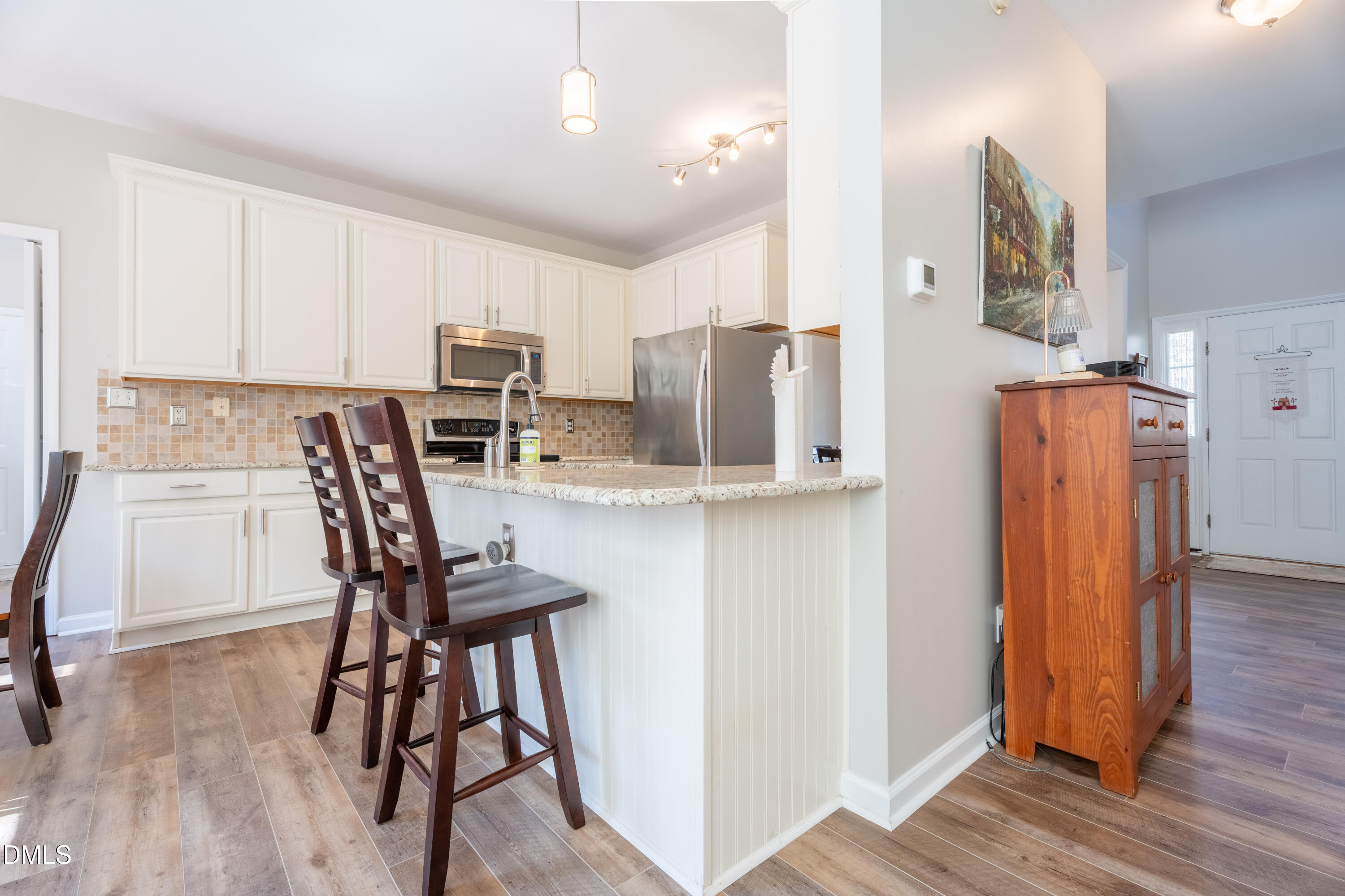 1305 Olde Walker Mill Road Apex, NC 27502 - Photo 32 of 41 a kitchen with stainless steel appliances a refrigerator and a stove top oven