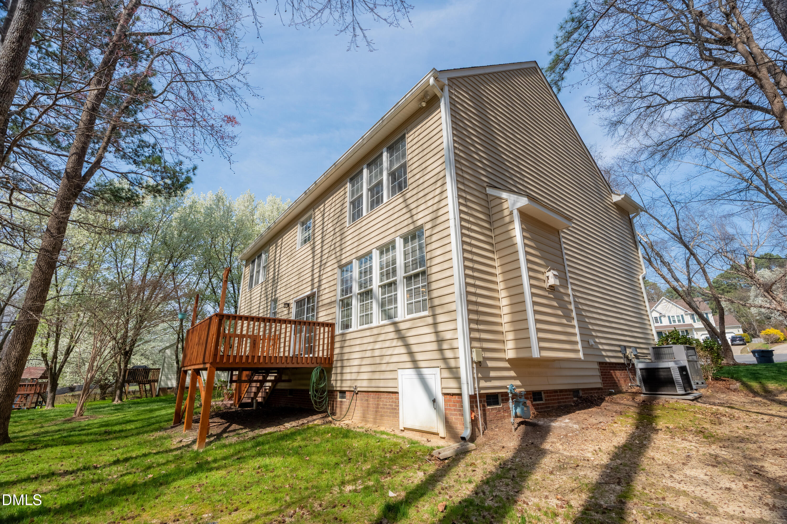 1305 Olde Walker Mill Road Apex, NC 27502 - Photo 37 of 41 a backyard of a house with wooden fence and large trees