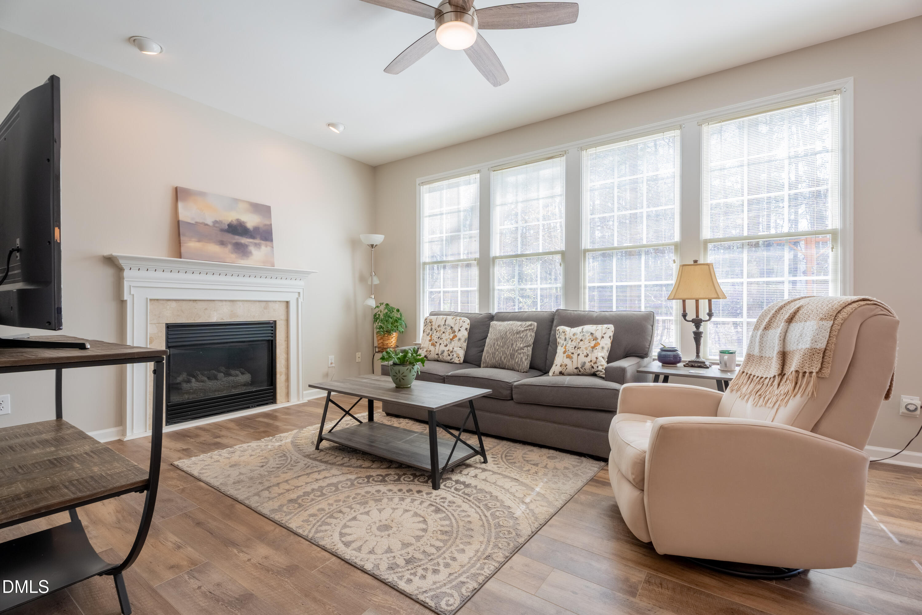 1305 Olde Walker Mill Road Apex, NC 27502 - Photo 4 of 41 a living room with furniture a fireplace and a large window