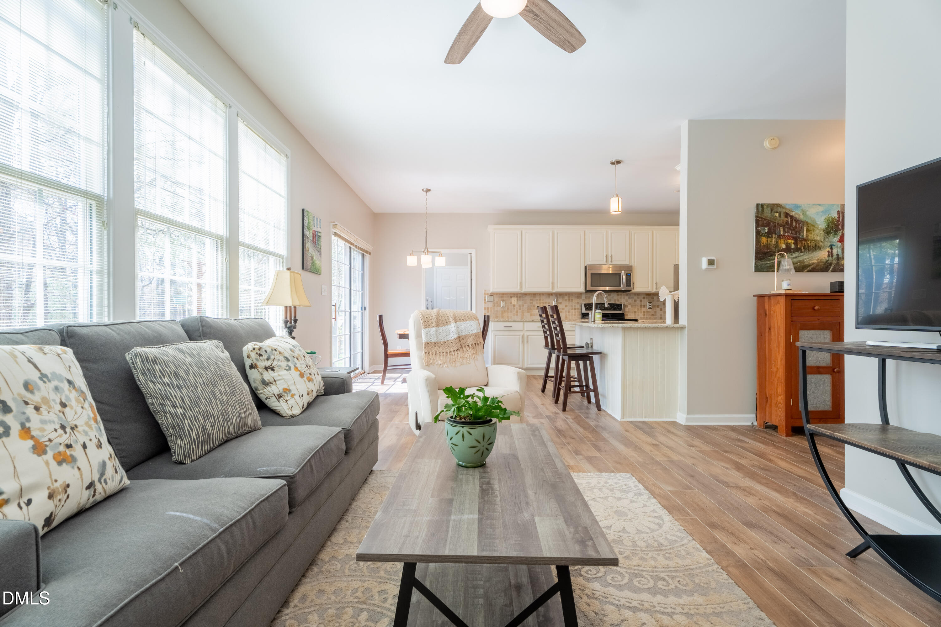 1305 Olde Walker Mill Road Apex, NC 27502 - Photo 5 of 41 a living room with furniture a flat screen tv and a large window