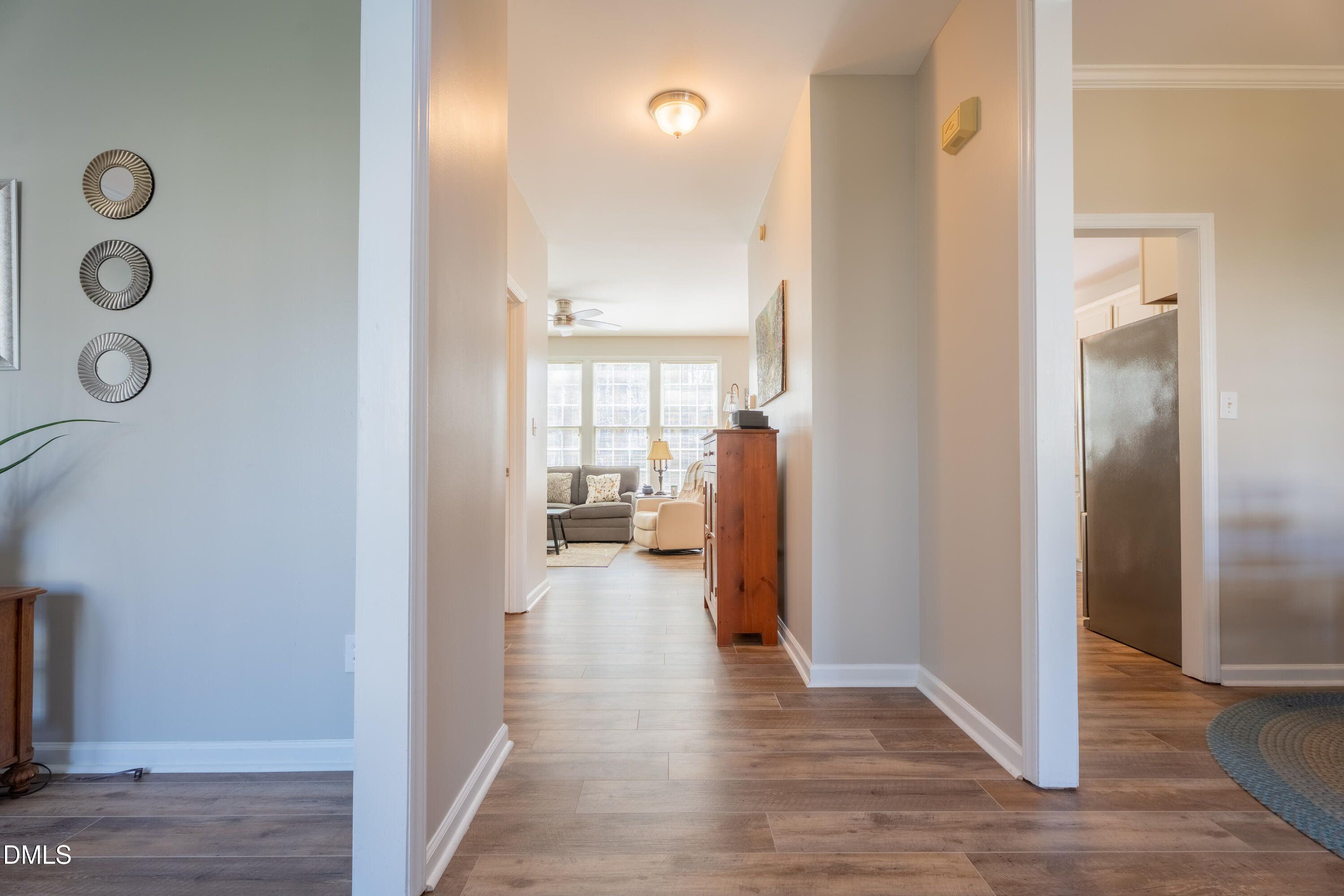 1305 Olde Walker Mill Road Apex, NC 27502 - Photo 10 of 41 a view of a hallway with wooden floor windows and livingroom with living room