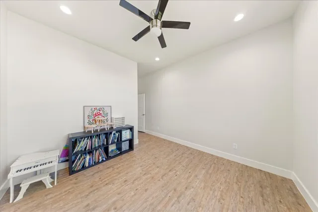 a spacious bedroom with a bed and a chandelier