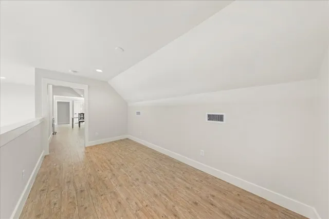a view of a room with wooden floor