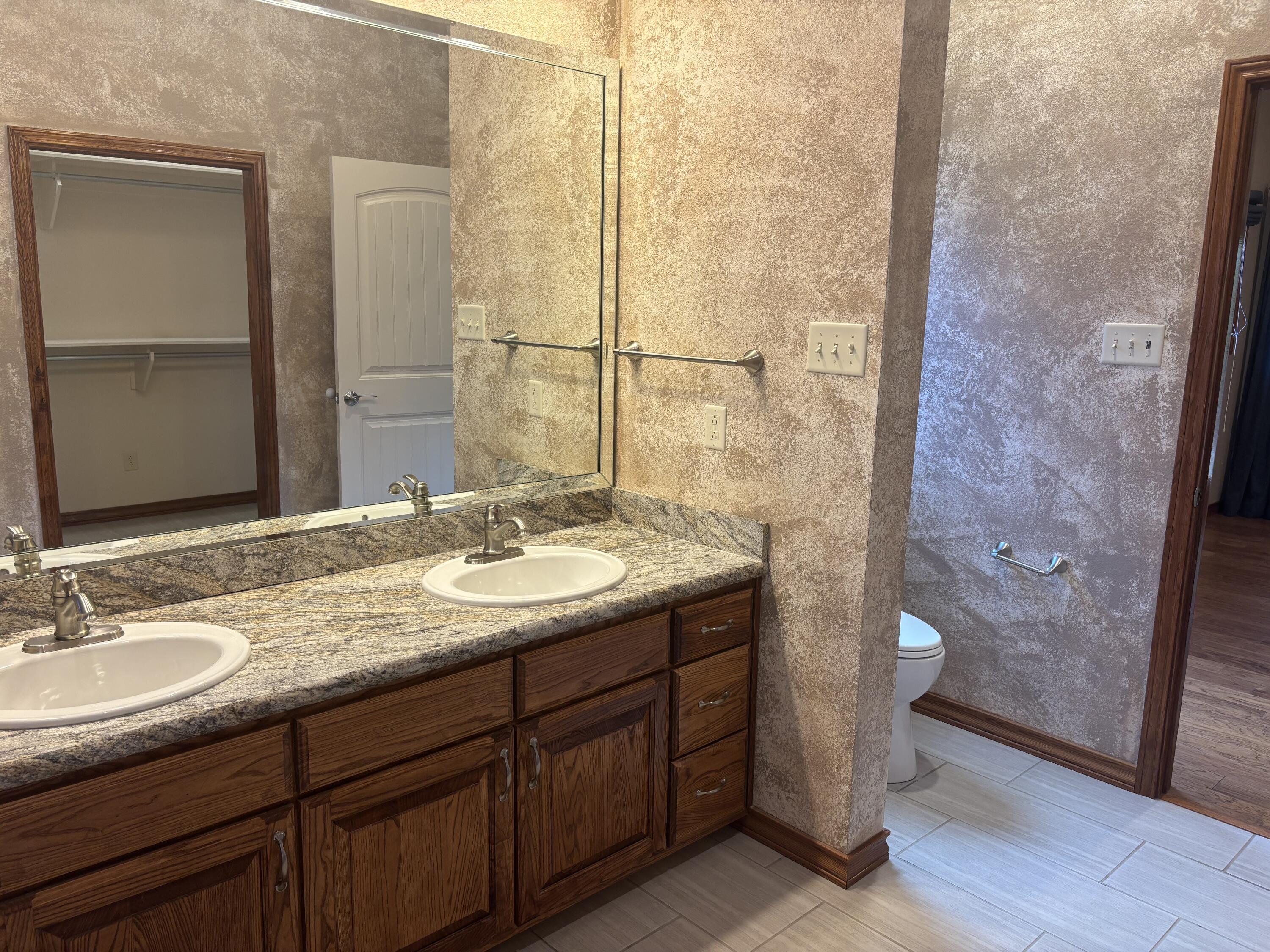 33 West Lakeshore Drive Ransom Canyon, TX 79366 - Photo 31 of 48 a bathroom with a granite countertop sink and a mirror