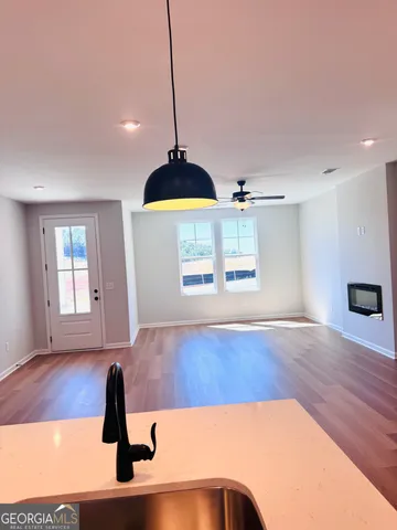 a view of a kitchen with a tub and wooden floor