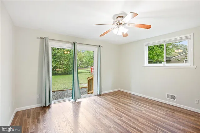 a view of a livingroom with a ceiling fan and window