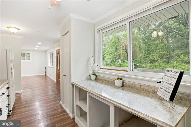 a view of a kitchen with a sink and wooden floor