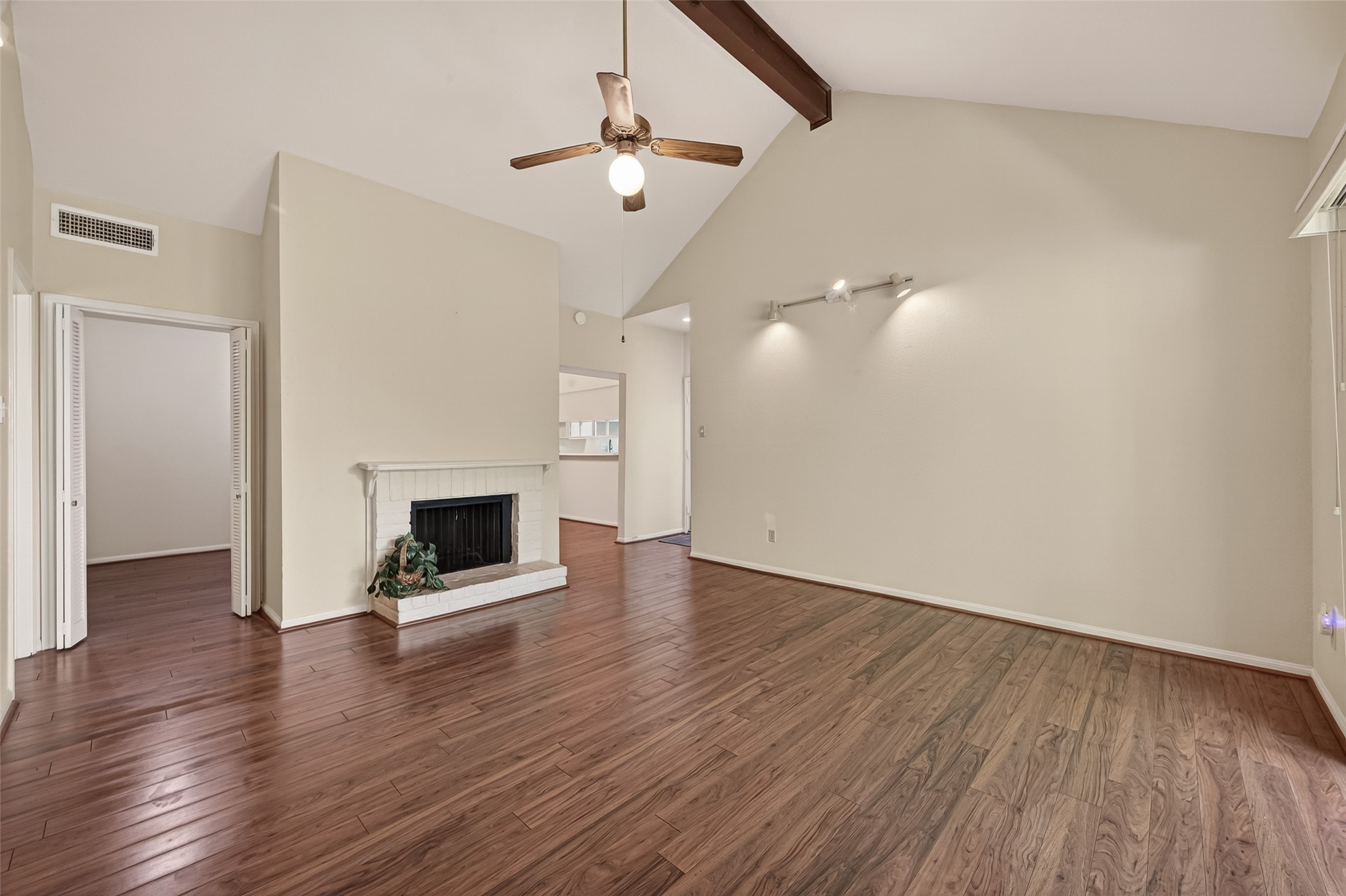 2100 Tanglewilde Street, Unit 596 Houston, TX 77063 - Photo 3 of 32 Living room has fireplace, book shelves and ceiling fan. See study to left