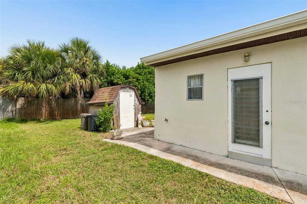 6634 Manor Beach Road New Port Richey, FL 34652 - Photo 36 of 64 a view of a backyard with plants and large trees