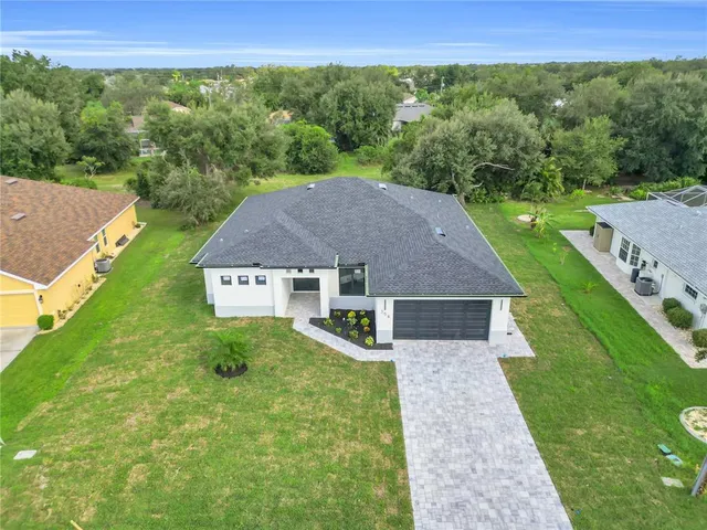 a aerial view of a house with yard