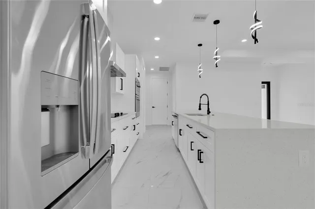 a spacious bathroom with double vanity and mirrors