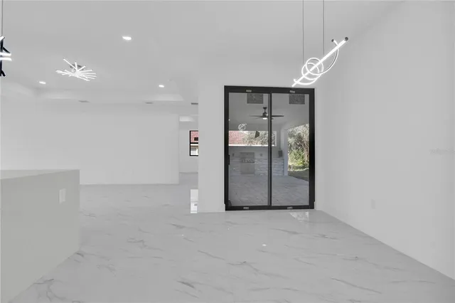 an empty room with entrance and windows