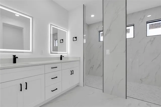 a spacious bathroom with double sink and shower