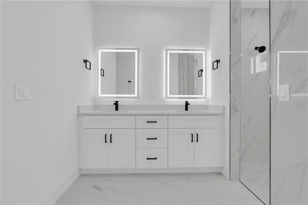 a bathroom with double sink and a mirror