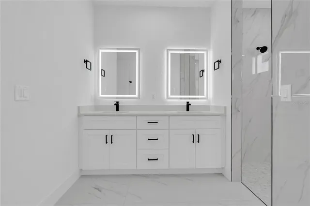 a bathroom with double sink and a mirror