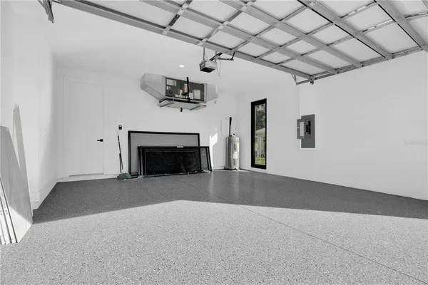 an empty room with windows and fireplace