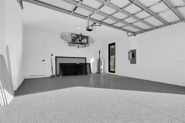 an empty room with windows and fireplace