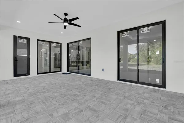 a view of a livingroom with a ceiling fan and window