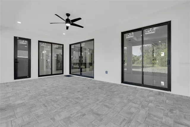 a view of a livingroom with a ceiling fan and window