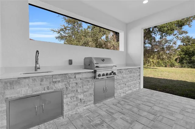 a kitchen with stainless steel appliances a stove a sink and a microwave