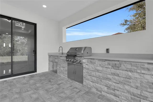 a kitchen with granite countertop a sink stove and cabinets