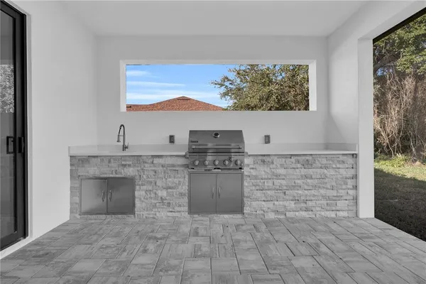a living room with a fireplace cabinet and a large window