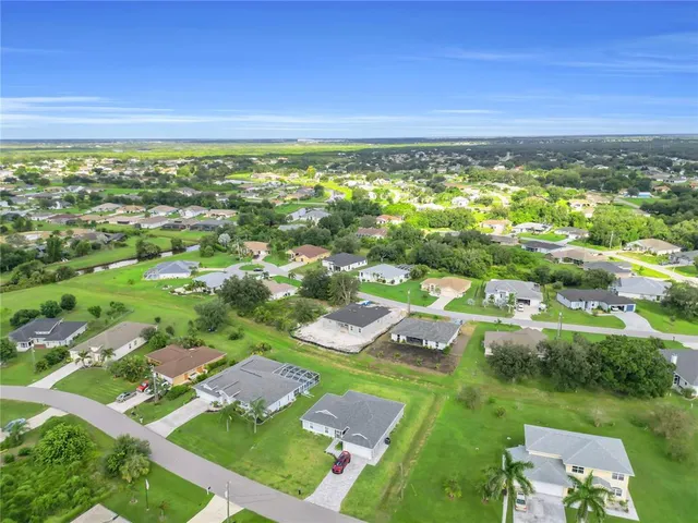 an aerial view of residential houses with outdoor space and street view