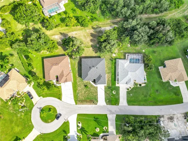 an aerial view of a house with outdoor space pool seating area and yard