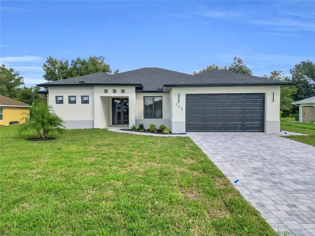 a front view of a house with a yard and garage