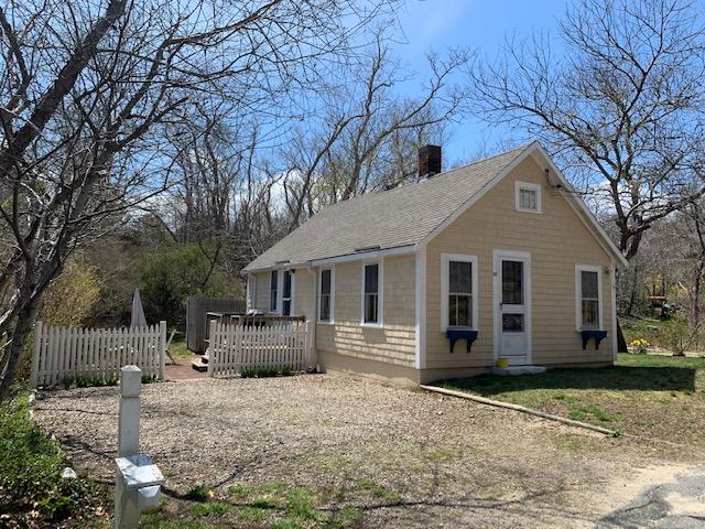 51 Mill Hill Road Wellfleet, MA 02667 - Photo 2 of 26 a front view of a house with a yard
