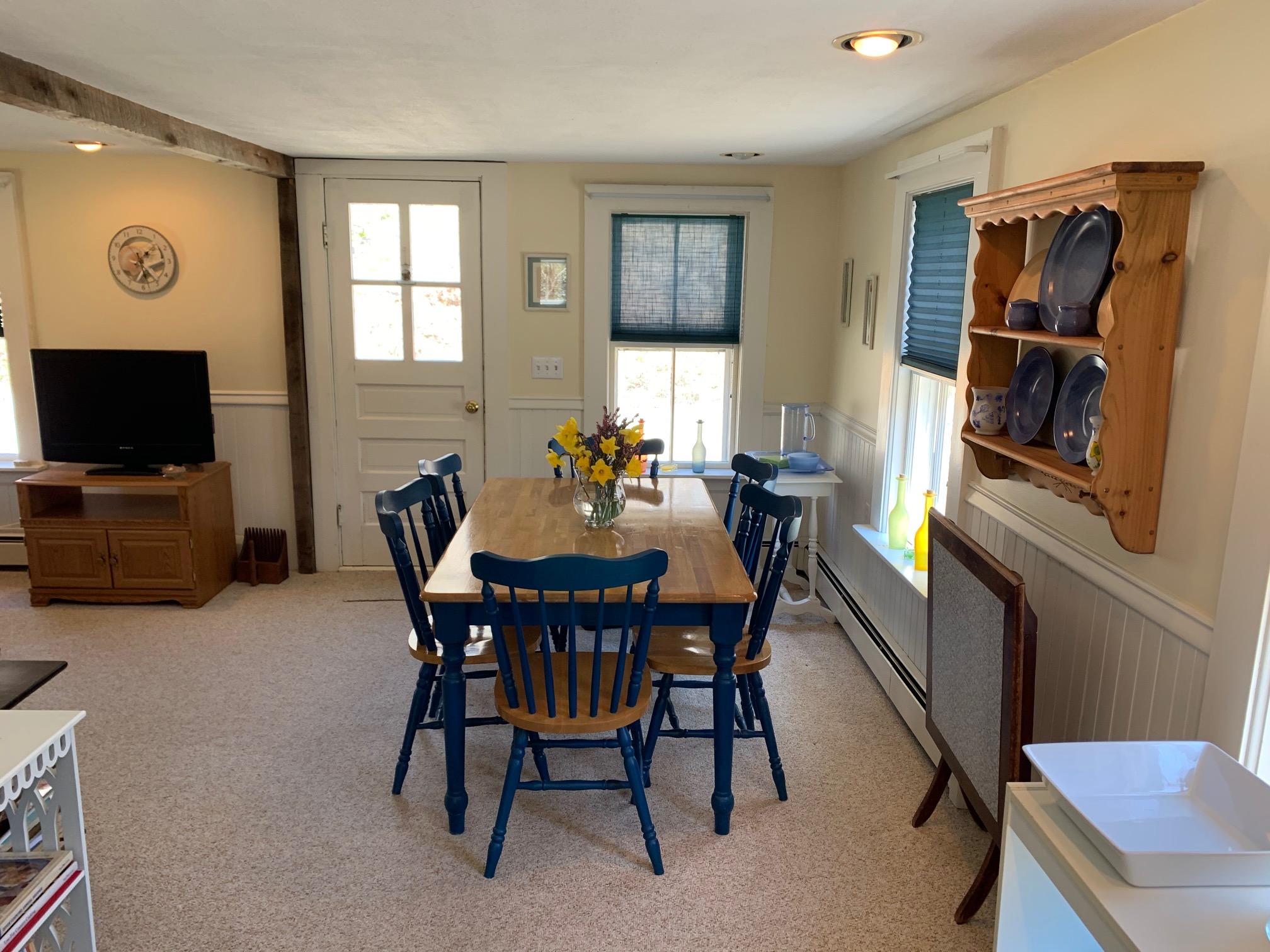 51 Mill Hill Road Wellfleet, MA 02667 - Photo 8 of 26 a view of a dining room with furniture and a flat screen tv