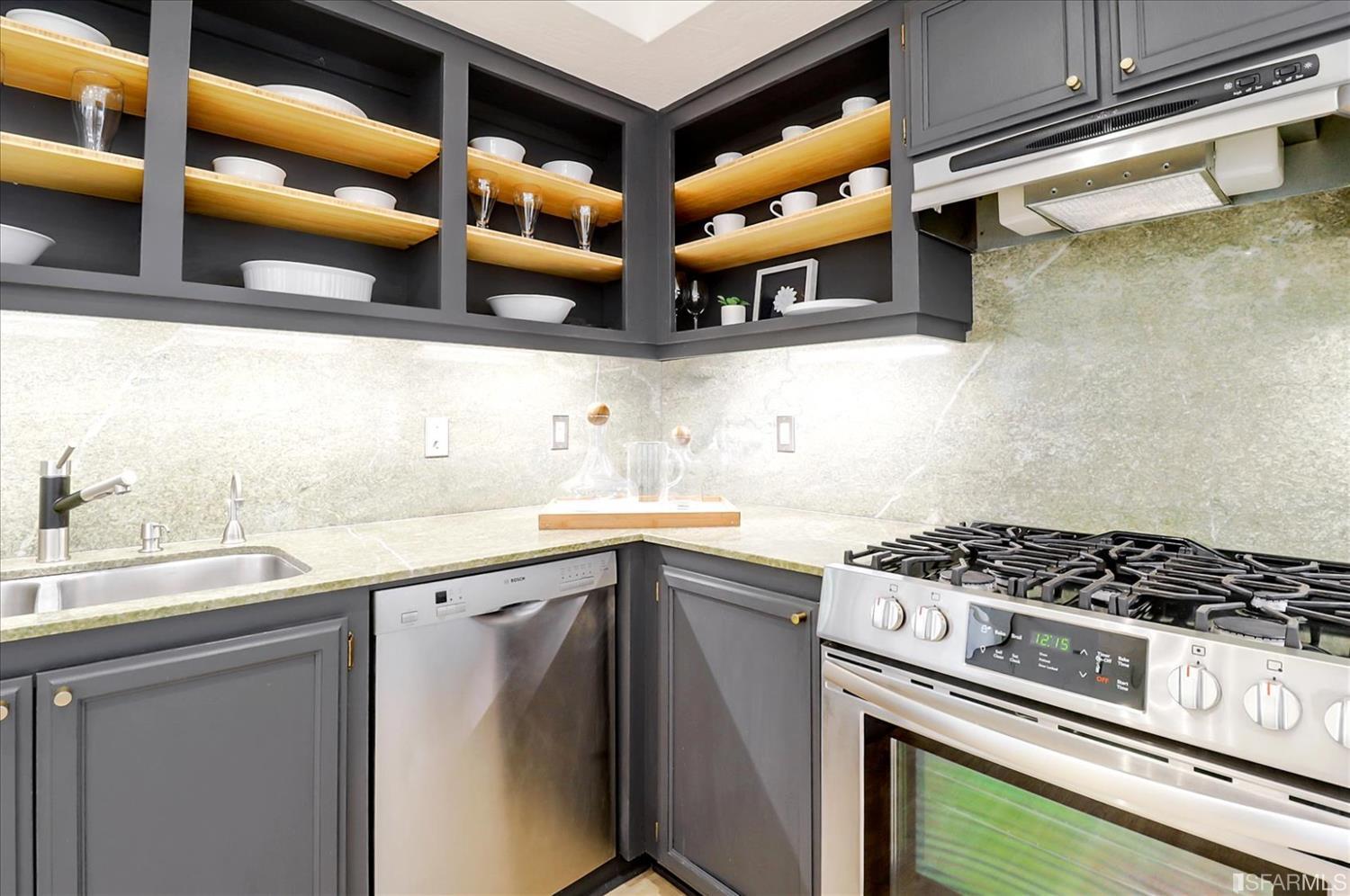 1397 Delaware Street Berkeley, CA 94702 - Photo 15 of 43 a kitchen with stainless steel appliances granite countertop a sink and cabinets