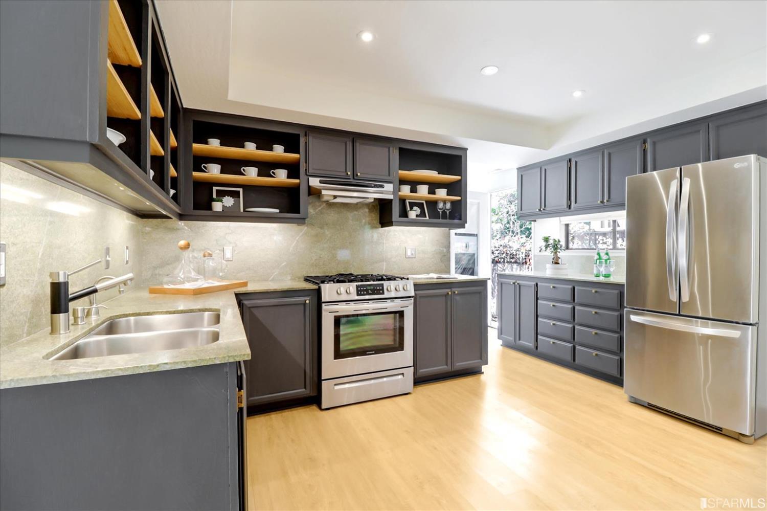 1397 Delaware Street Berkeley, CA 94702 - Photo 19 of 43 a kitchen with stainless steel appliances granite countertop a refrigerator and a sink