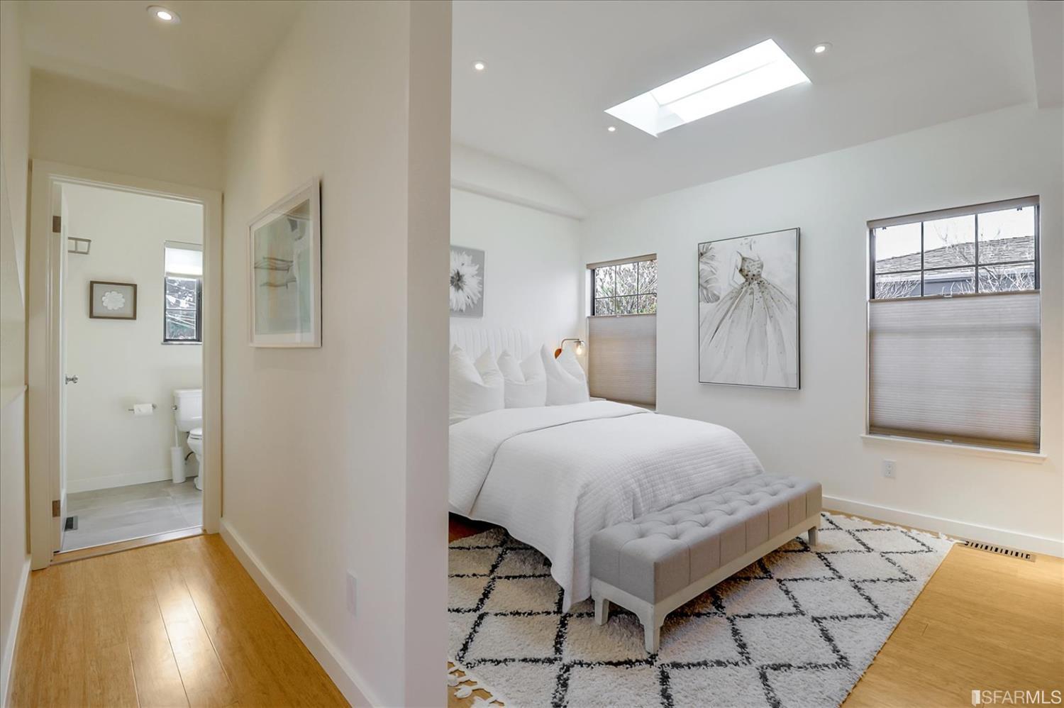 1397 Delaware Street Berkeley, CA 94702 - Photo 26 of 43 a spacious bedroom with a bed and a table in it