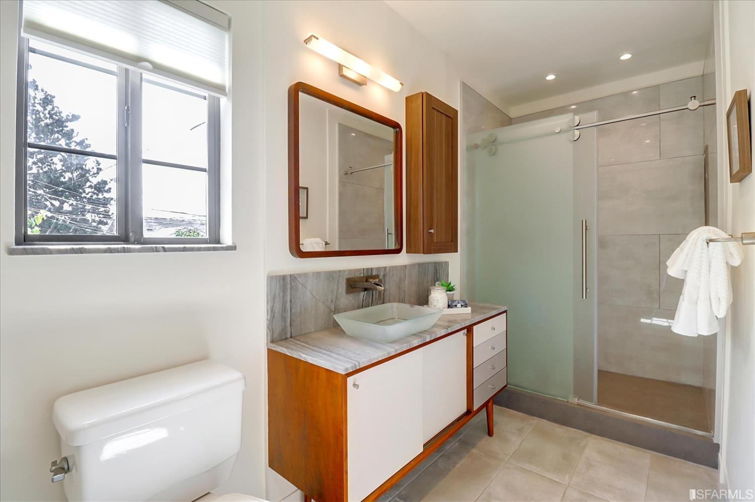 1397 Delaware Street Berkeley, CA 94702 - Photo 27 of 43 a bathroom with a sink a toilet and shower