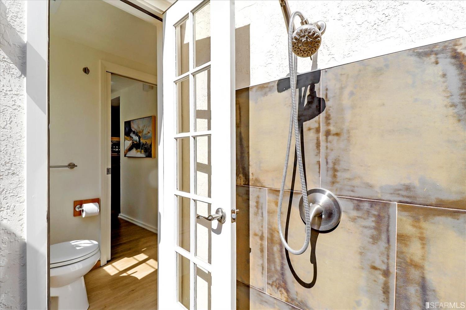 1397 Delaware Street Berkeley, CA 94702 - Photo 30 of 43 a bathroom with a granite countertop shower and a toilet