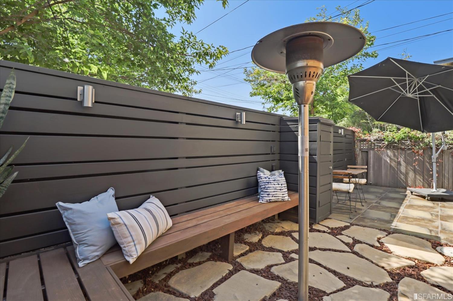 1397 Delaware Street Berkeley, CA 94702 - Photo 35 of 43 a roof deck with table and chairs under an umbrella