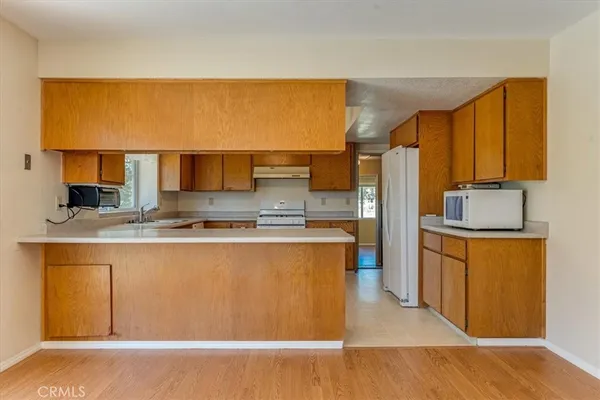 a kitchen with stainless steel appliances a refrigerator and a cabinets