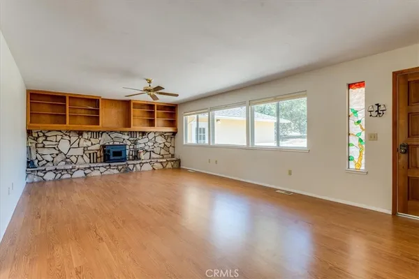 a view of a livingroom with furniture wooden floor and window