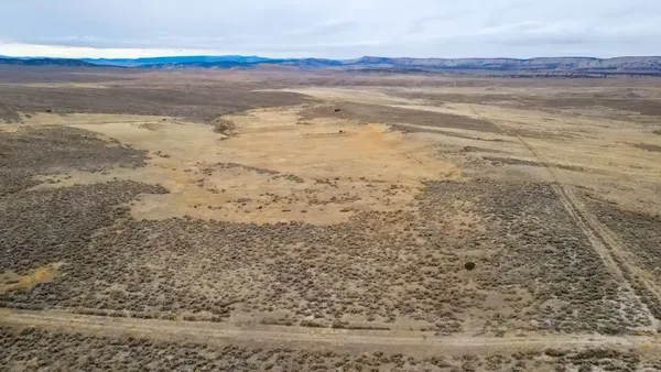 a backyard of a house with yard and outdoor seating