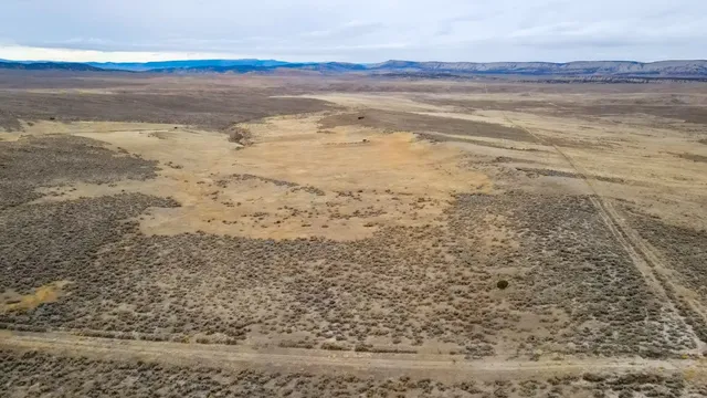 a backyard of a house with yard and outdoor seating
