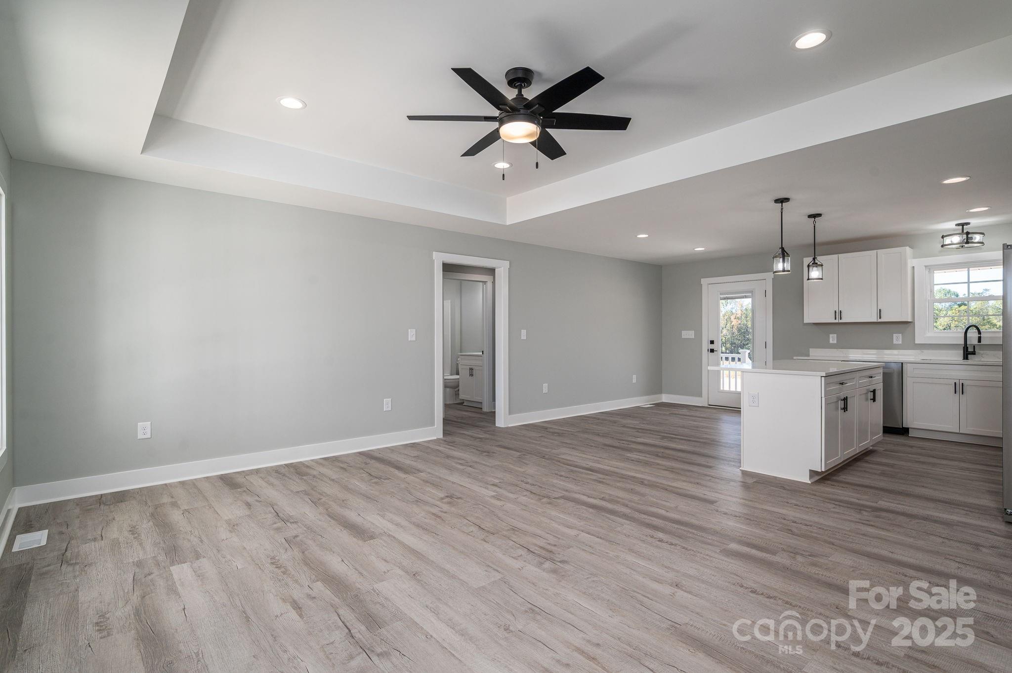 367 Northbrook III School Road Vale, NC 28168 - Photo 14 of 40 a view of an empty room with kitchen appliances and a ceiling fan