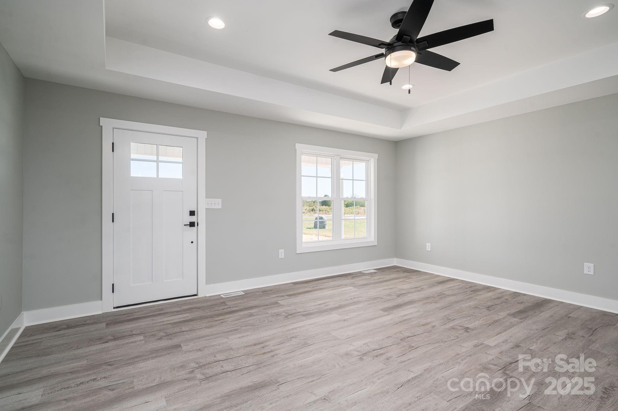367 Northbrook III School Road Vale, NC 28168 - Photo 15 of 40 an empty room with wooden floor fan and windows