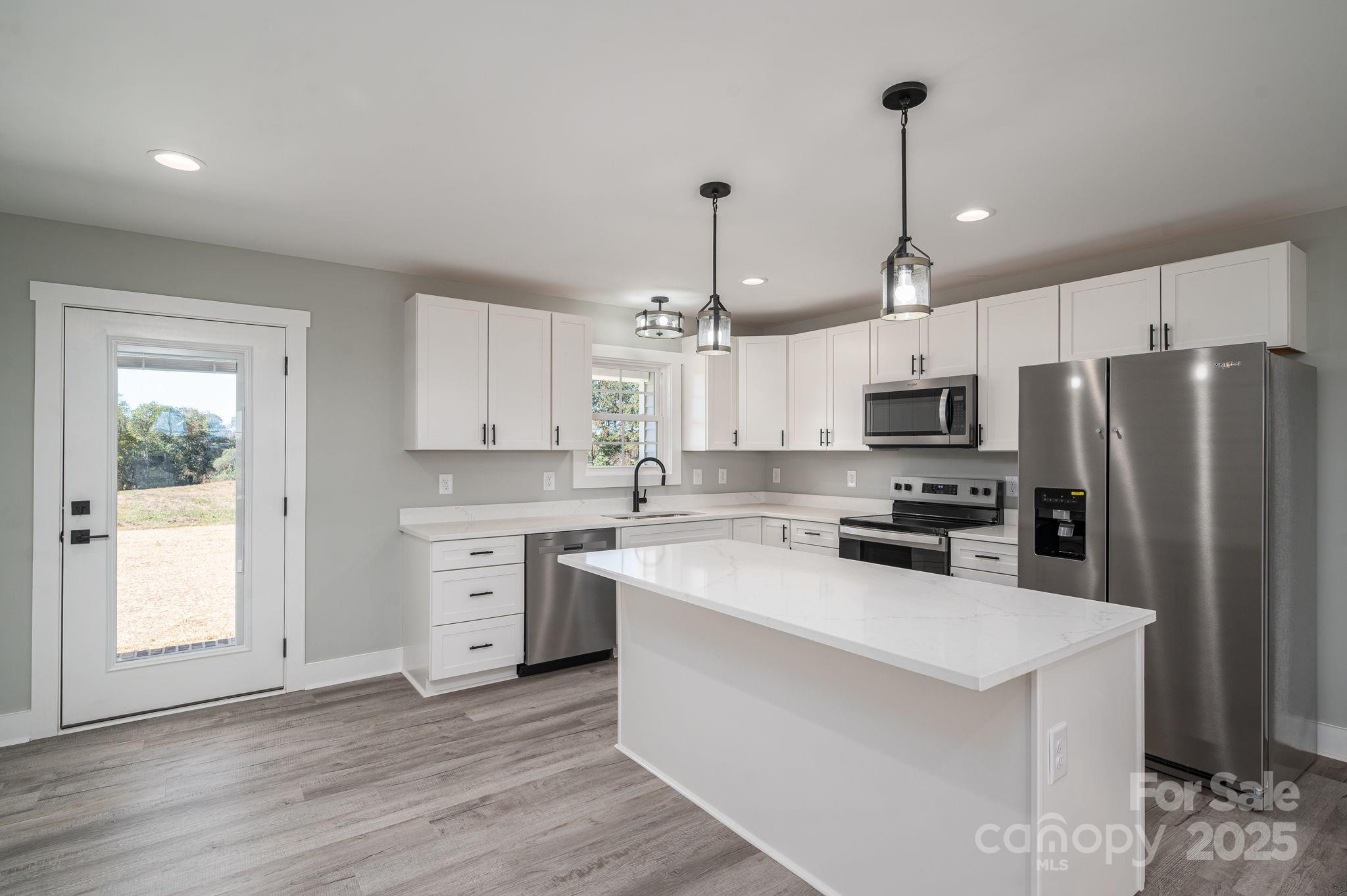 367 Northbrook III School Road Vale, NC 28168 - Photo 17 of 40 a kitchen with white cabinets and stainless steel appliances