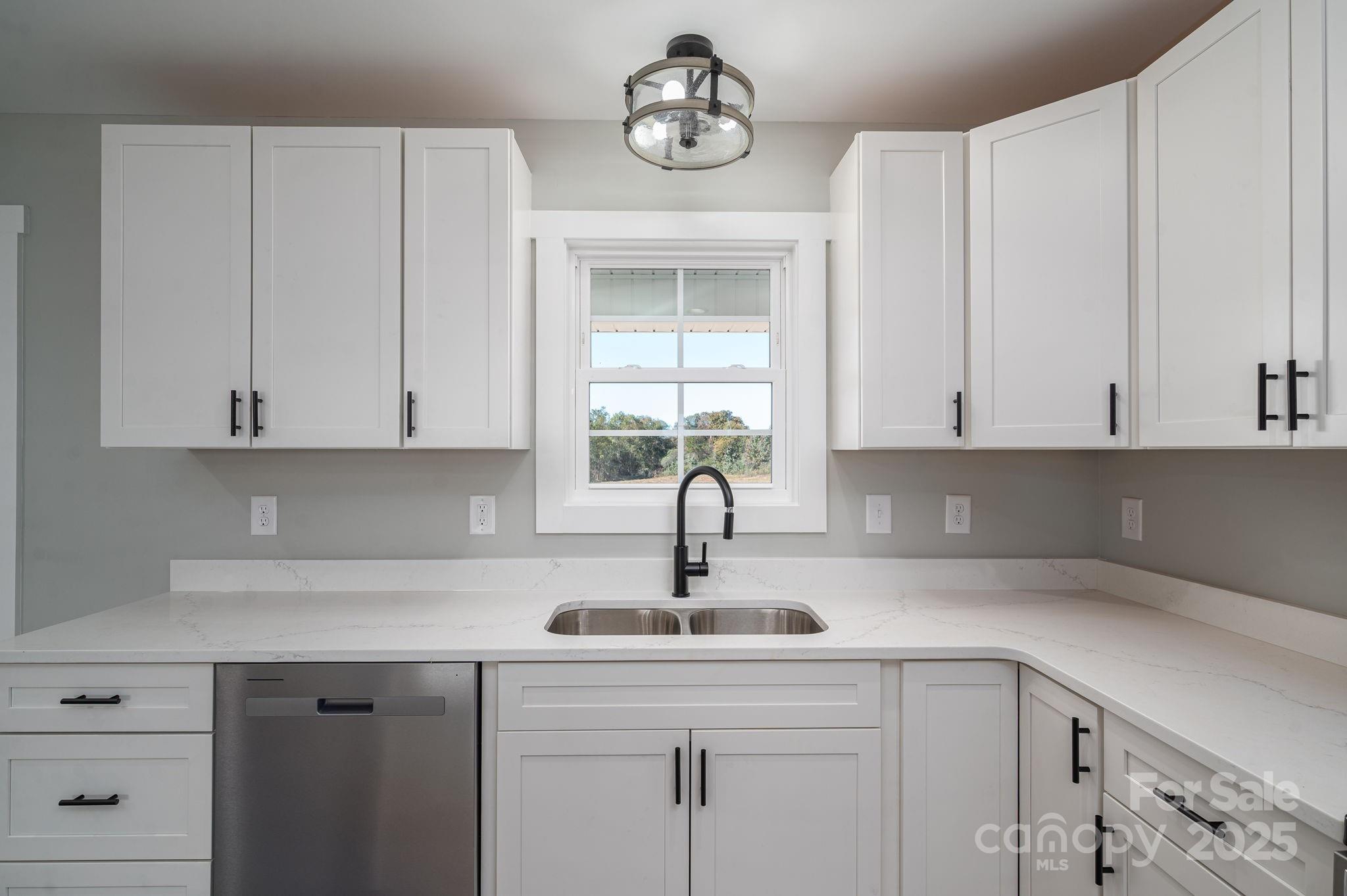 367 Northbrook III School Road Vale, NC 28168 - Photo 18 of 40 a kitchen with white cabinets a sink and dishwasher