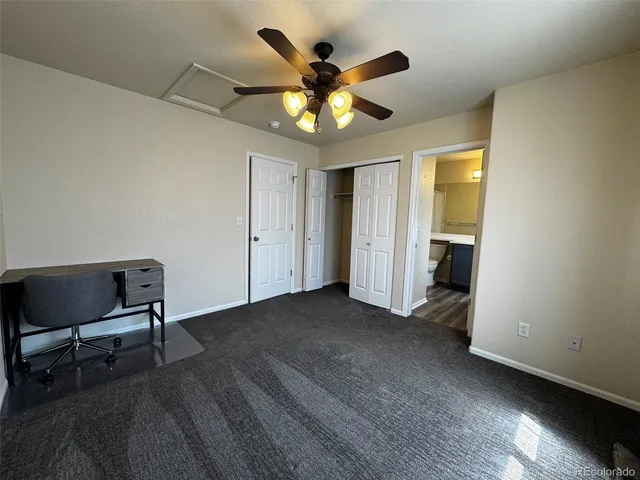 a view of an empty room with a ceiling fan and a window