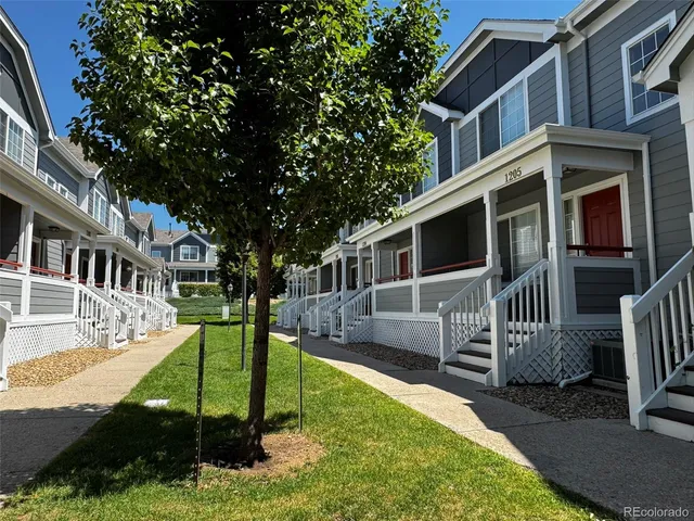 a front view of a house with a yard table and chairs