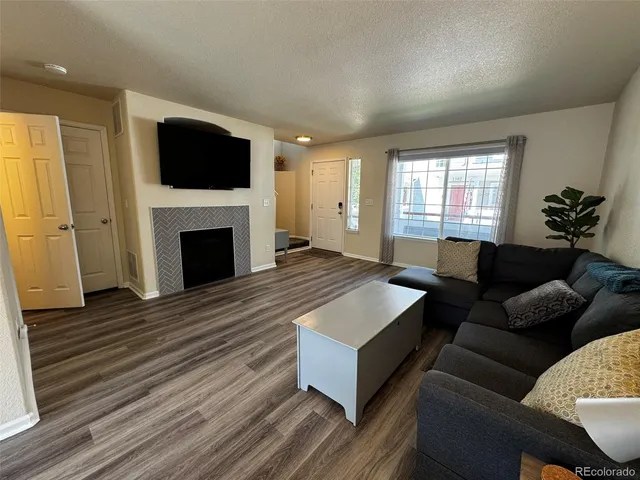 a living room with furniture flat screen tv and a fireplace