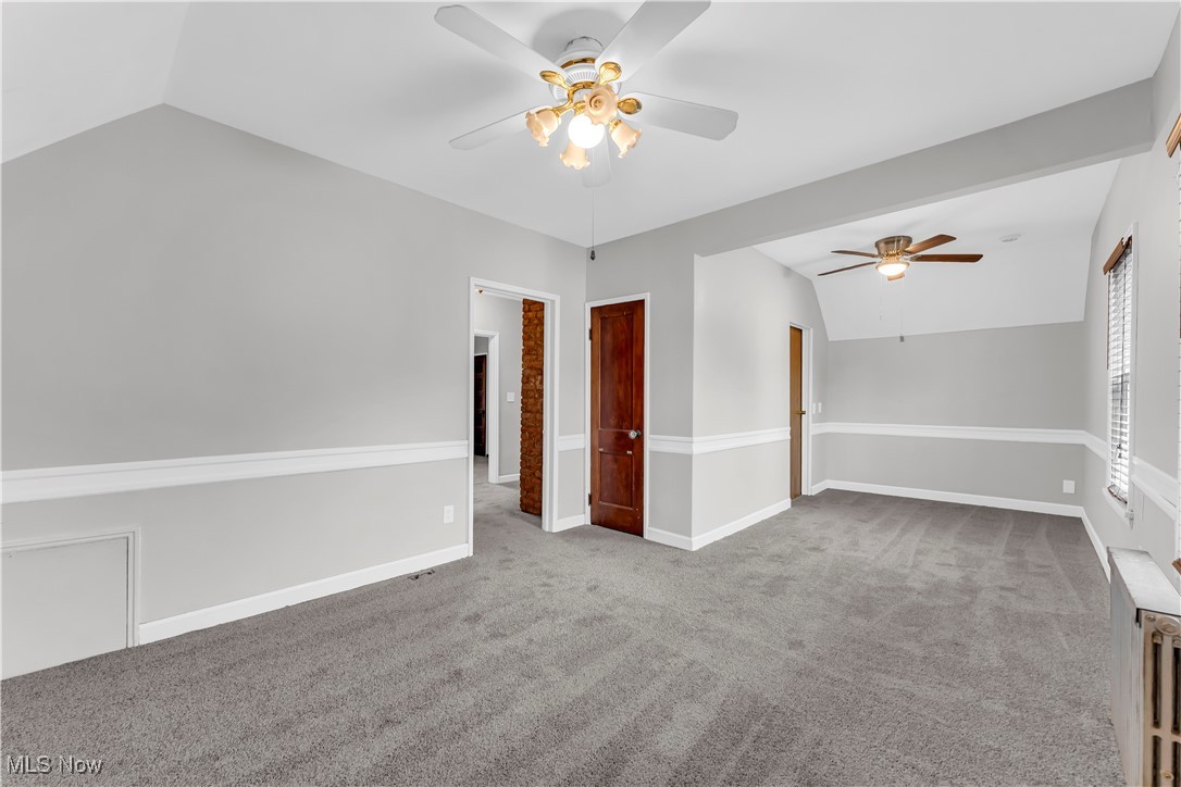 3374 Fulton Road Cleveland, OH 44109 - Photo 21 of 27 Empty room with lofted ceiling, carpet flooring, and ceiling fan